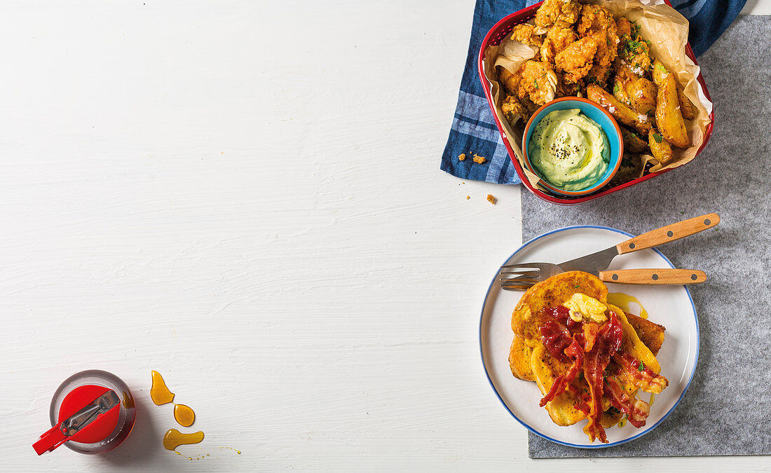 Southern fried chicken and French toast with crispy bacon and maple syrup