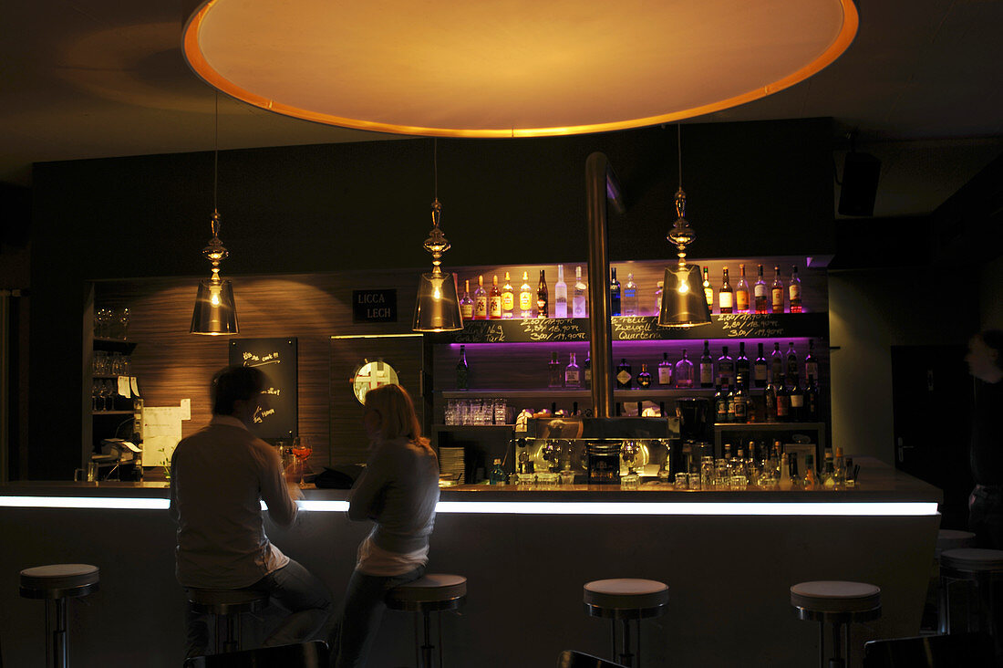The interior of a bar with dim lighting