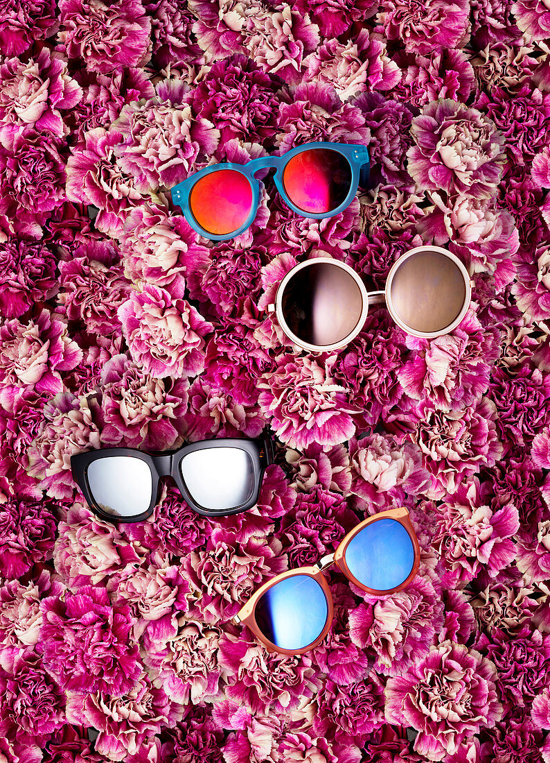 Sunglasses on a bed of carnations
