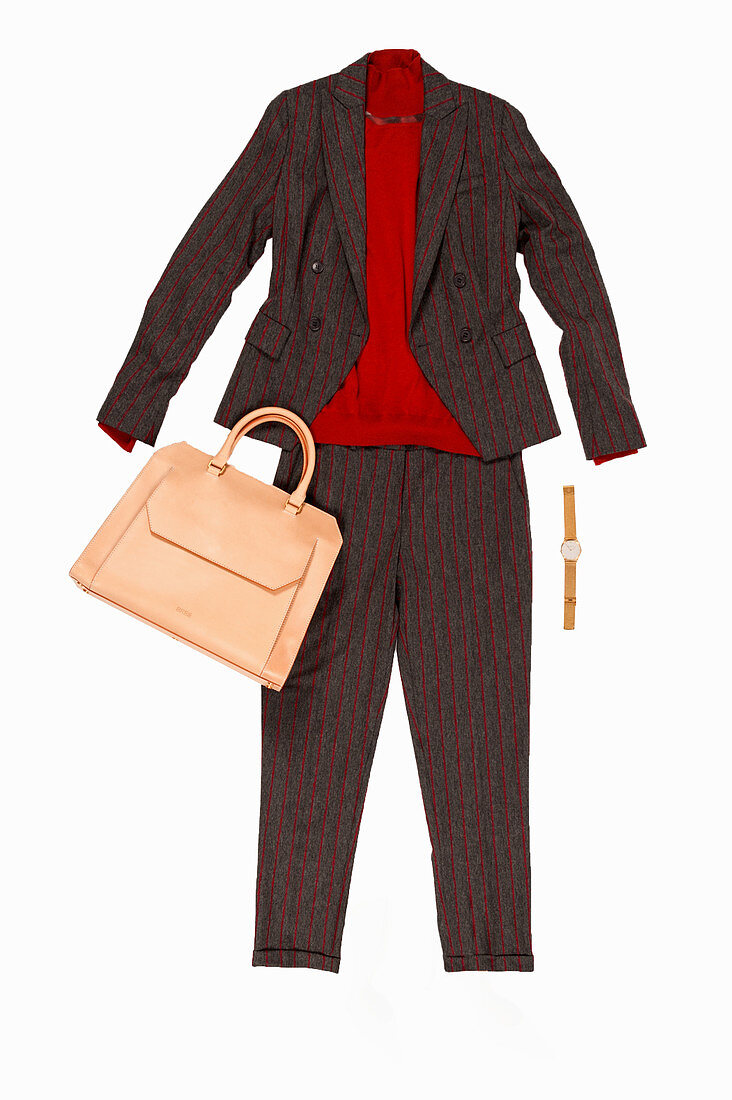 A pin-striped trouser suit made of a viscose-wool blend and a red turtle neck jumper, a handbag and a watch