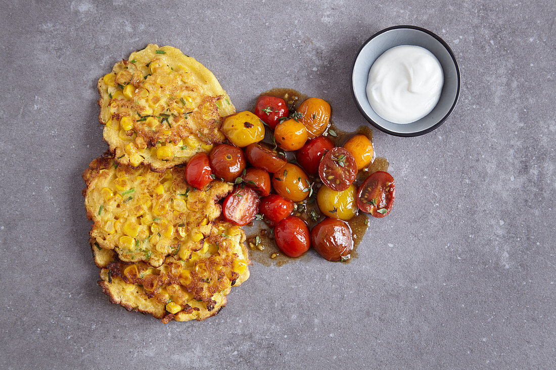 Sweetcorn fritters with braised tomatoes
