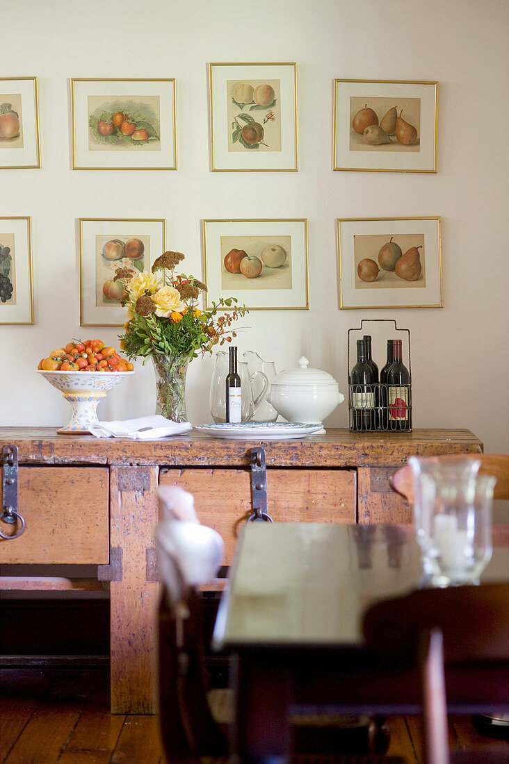 Pictures of fruit above old workbench used as sideboard