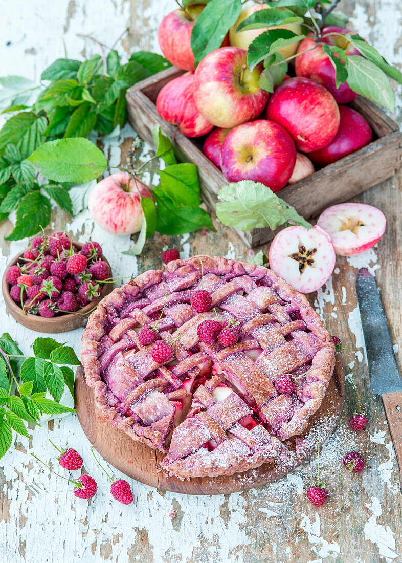 Apple pie with dried raspberry powder and raspberries