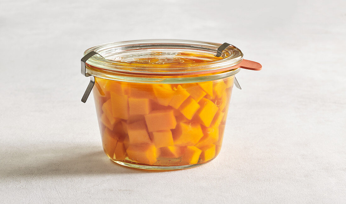 Sweet-and-sour pickled pumpkin in a preserving jar