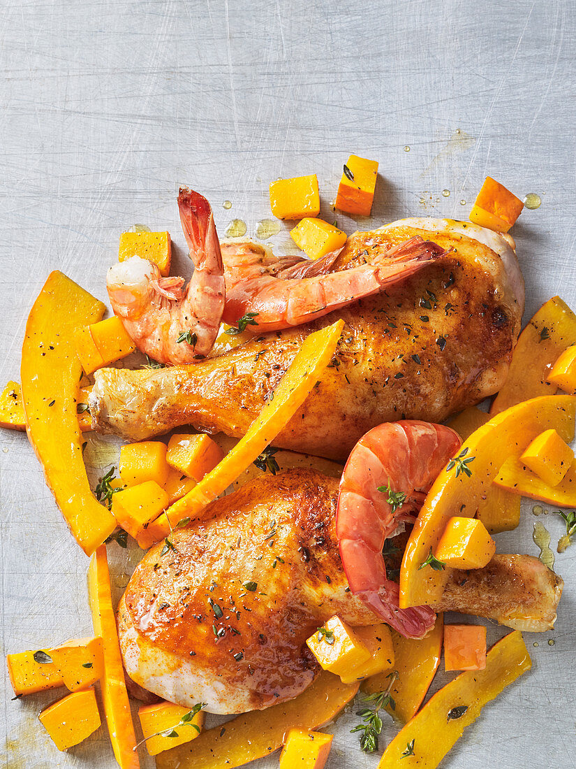 Chicken legs and prawns with oven-roasted pumpkin (seen from above)