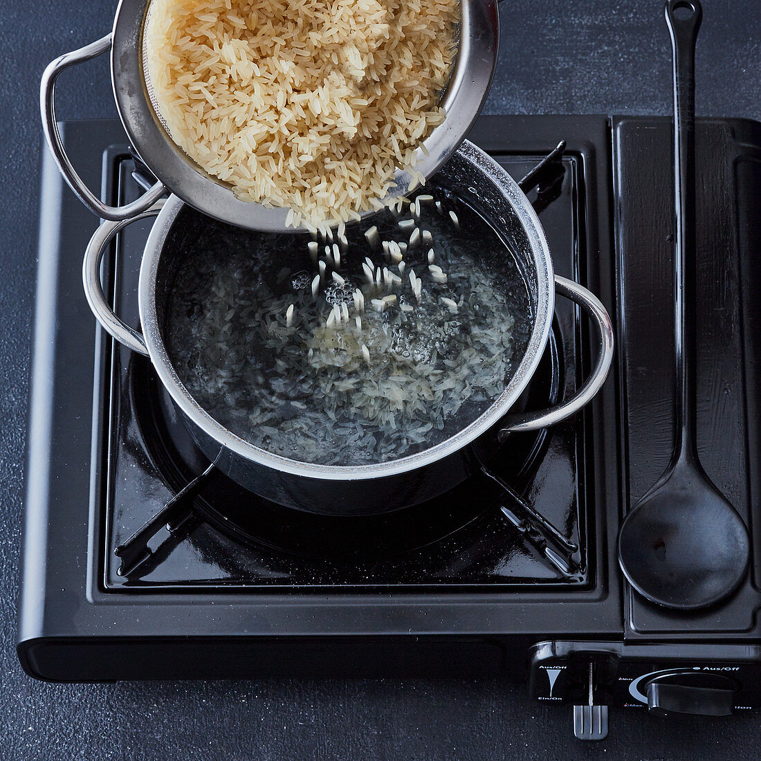 Rice being cooked - rice being added to water