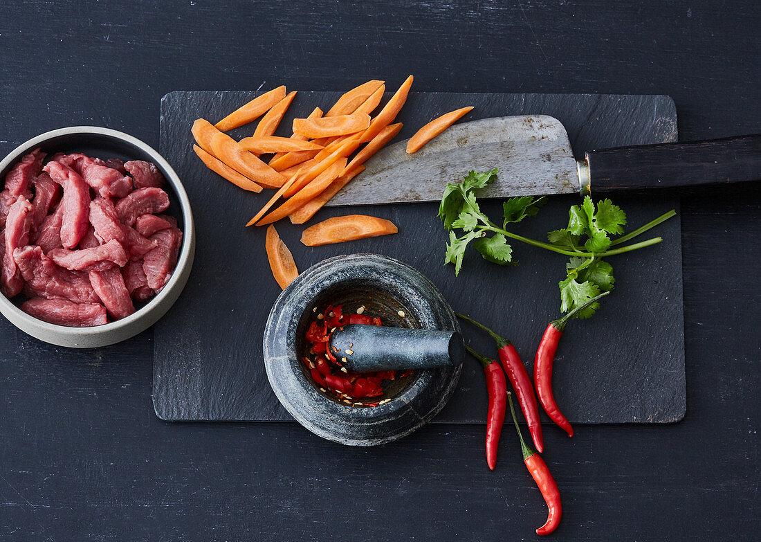 A stir-fry arrangement - meat, carrots, coriander and chilli