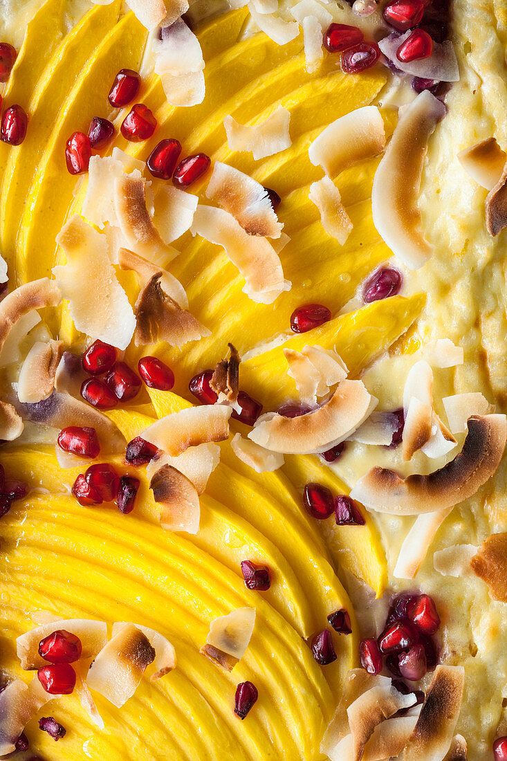 Coconut rice bake with mango, pomegranate seeds and coconut chips