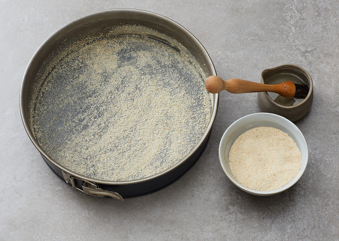 A greased baking tin sprinkled with breadcrumbs