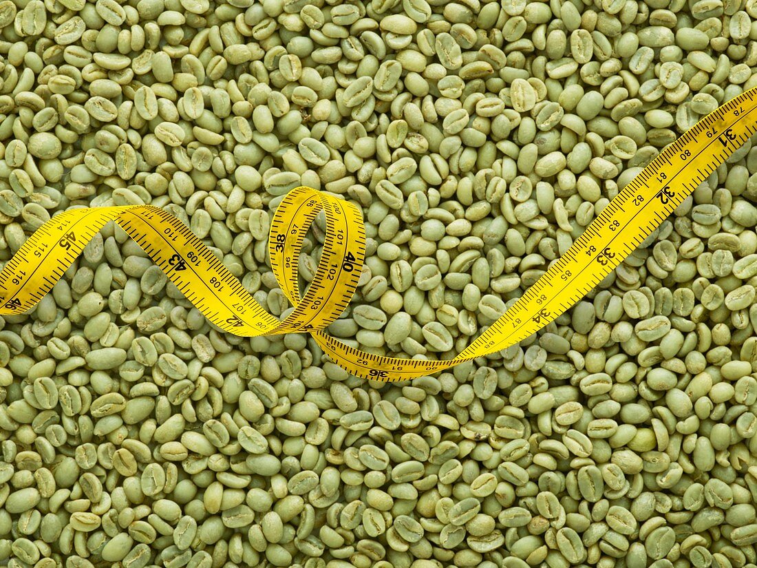 Green coffee beans and tape measure