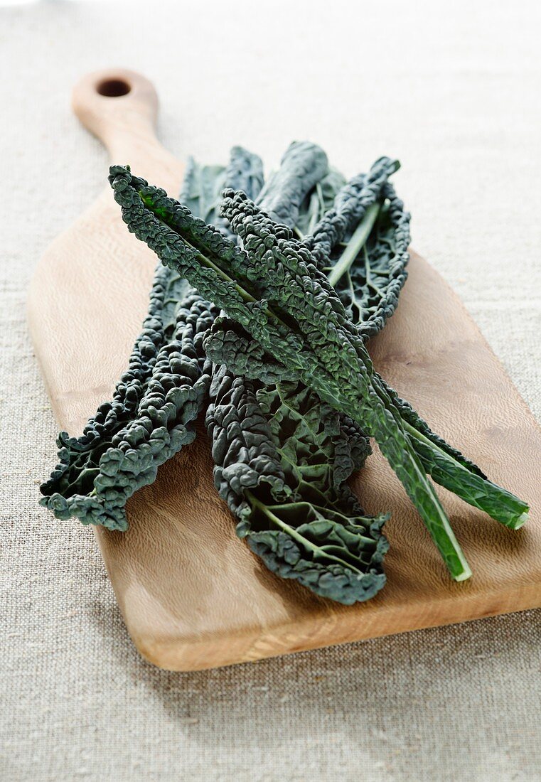 Kale on wooden chopping board