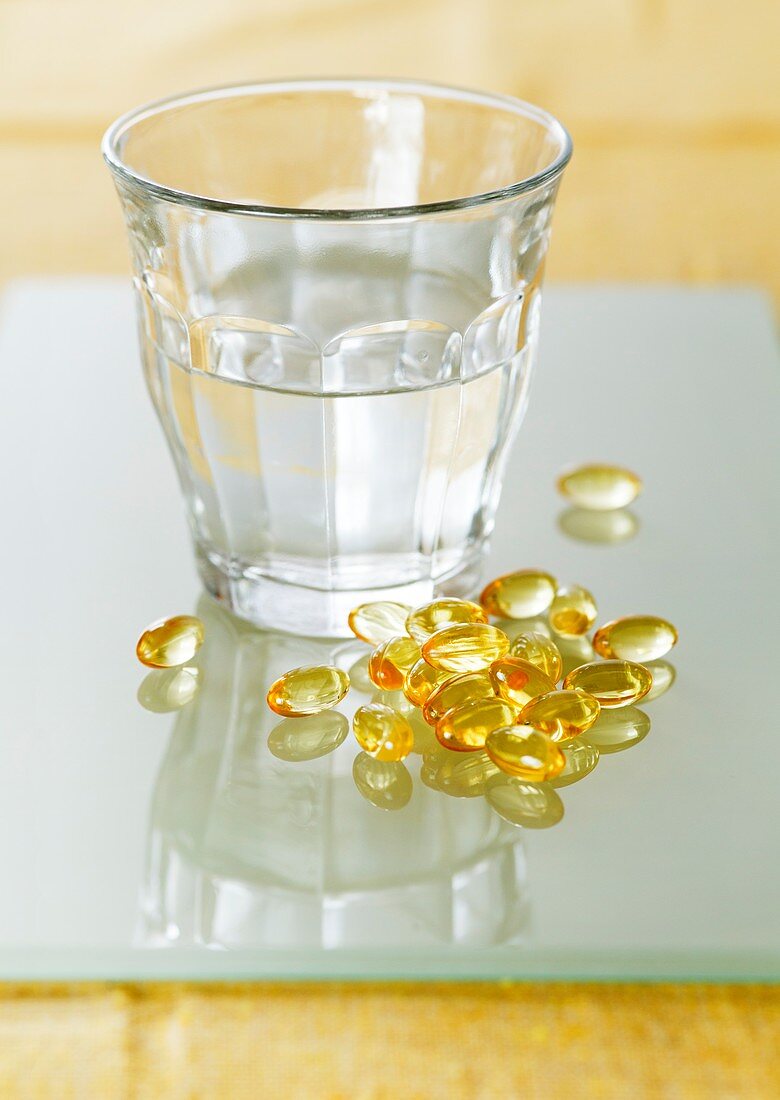 Evening primrose oil capsules and water