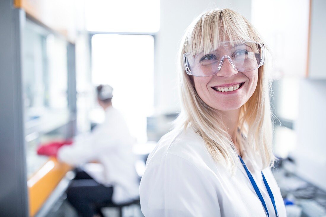 Doctor wearing protective goggles and smiling