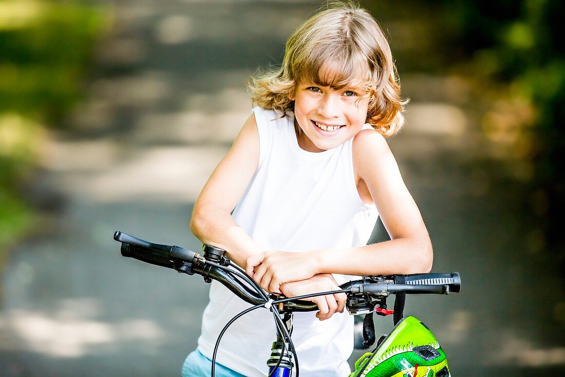 Boy sitting on bicycle