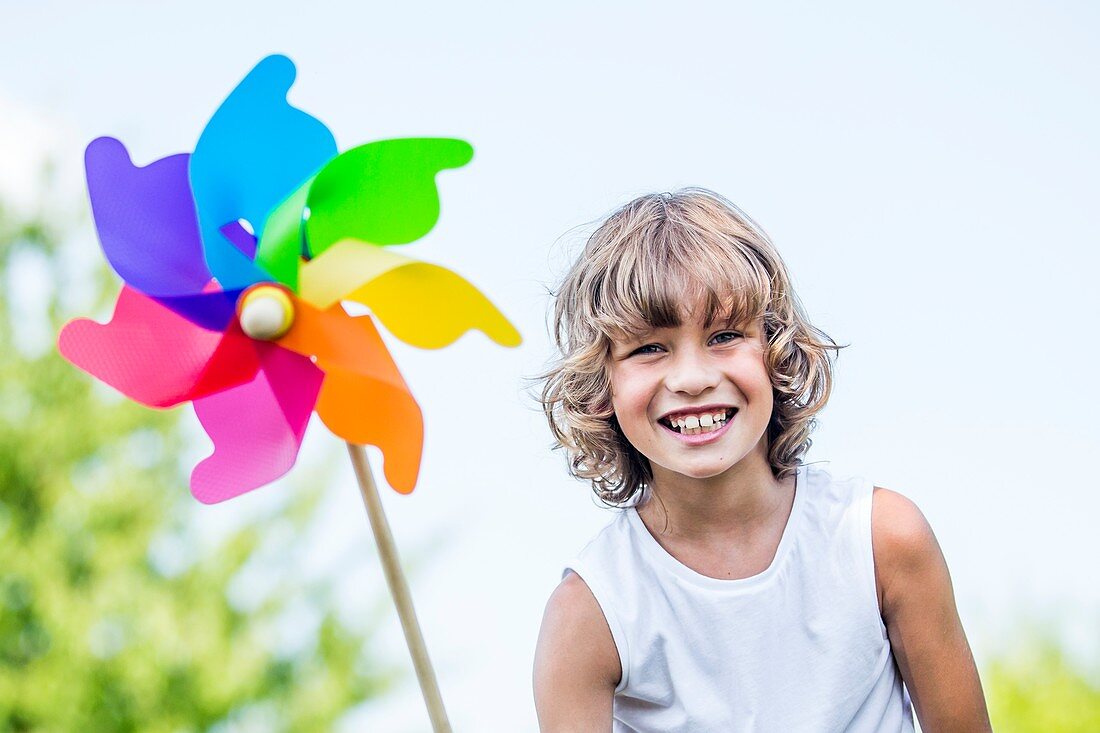 Boy holding paper windmill