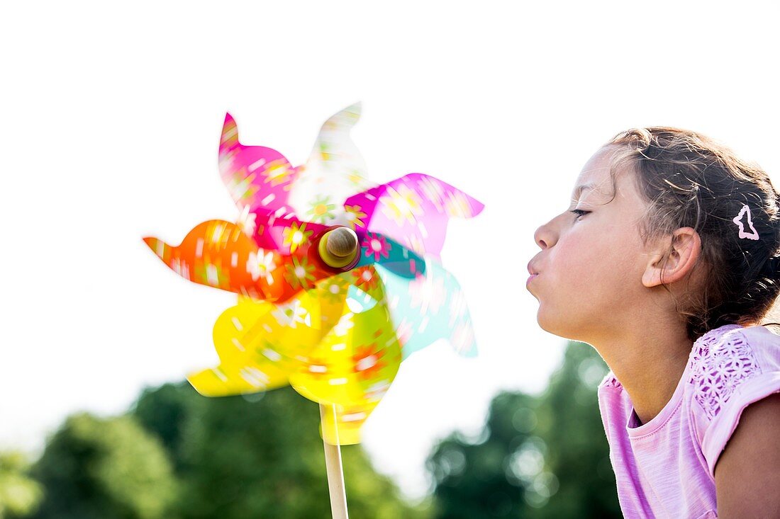 Girl blowing paper windmill