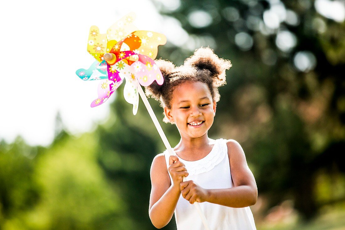 Girl holding paper windmill