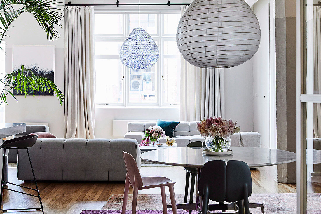 Open living room with round dining table and light gray sofa landscape