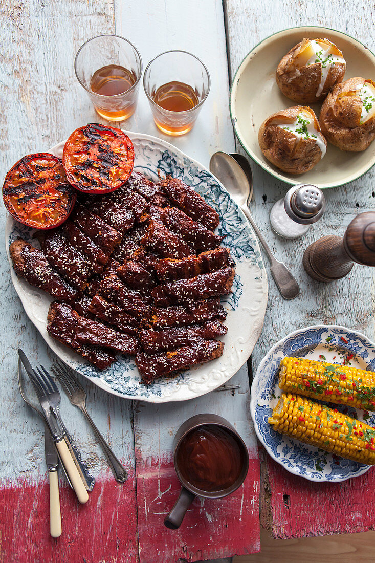 Vegan 'spare ribs' with jacket potatoes, oven-roasted tomatoes and sweetcorn