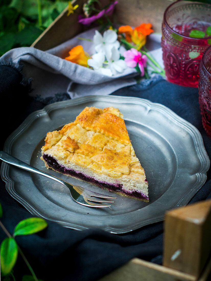 A piece of blueberry pie with goat's cream cheese for a picnic