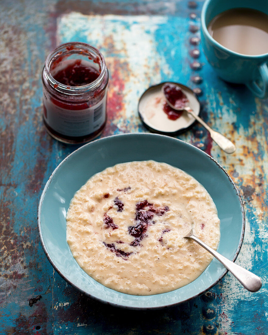 Rice pudding with raspberry jam, and a cup of coffee