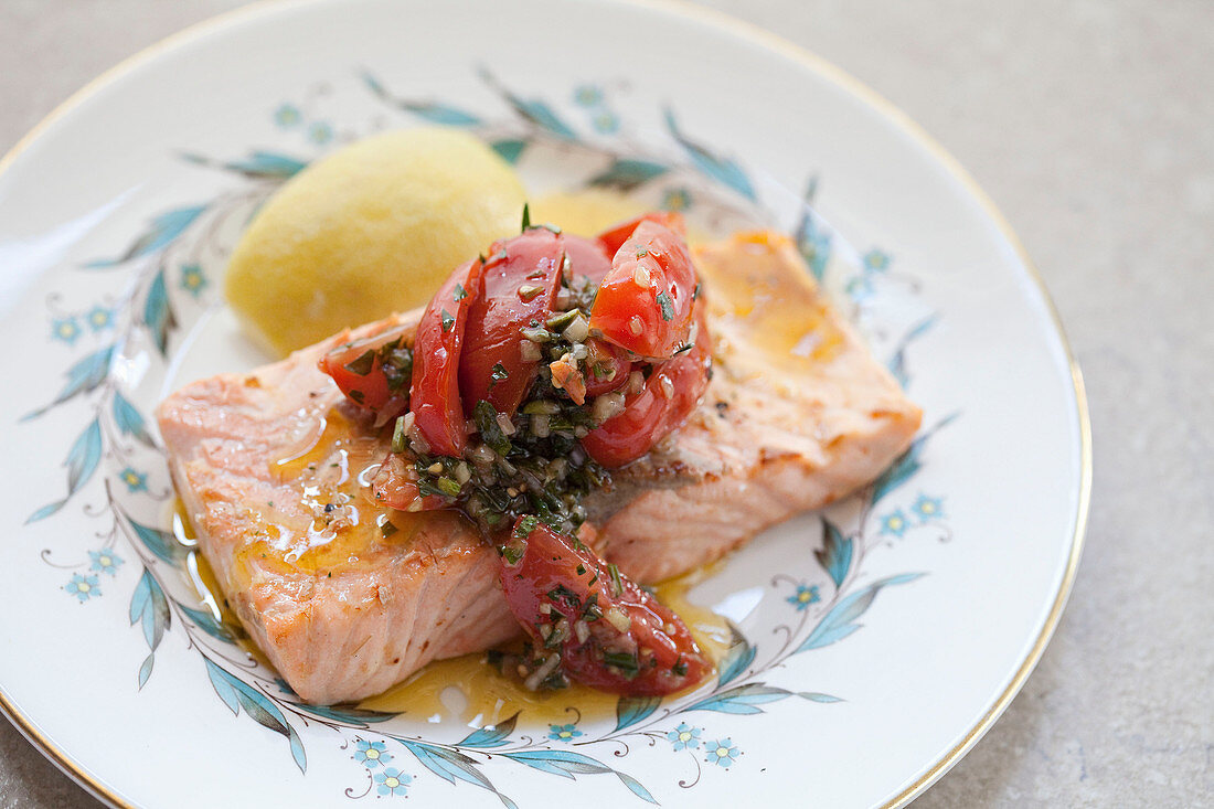 Salmon with a salsa verde and tomato topping