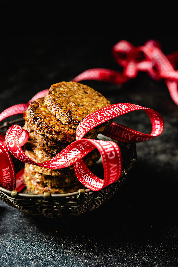 Spiced biscuits with walnuts, dates, coconut flakes and a Christmas ribbon