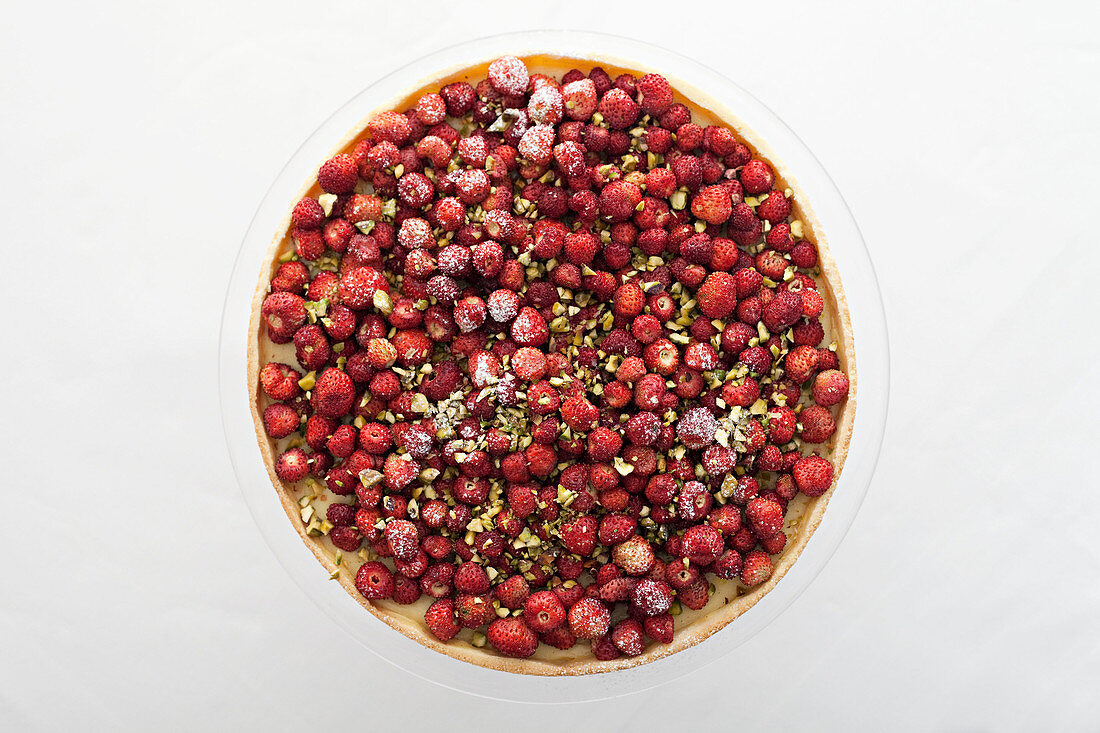 A strawberry and pistachio tart from above