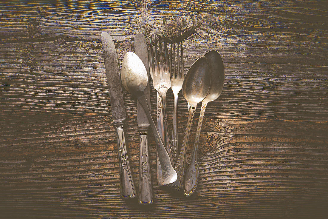 Antique cutlery on a wooden table