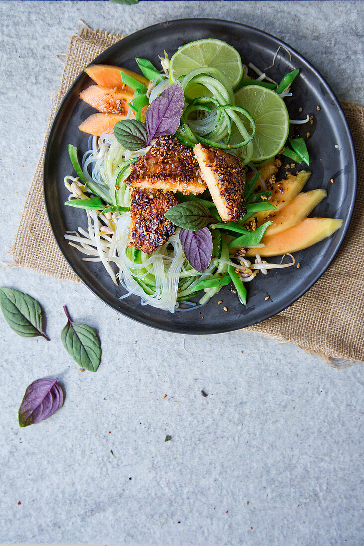 Velvet tofu on glass noodle salad with cucumber, papaya and lime (Asia)