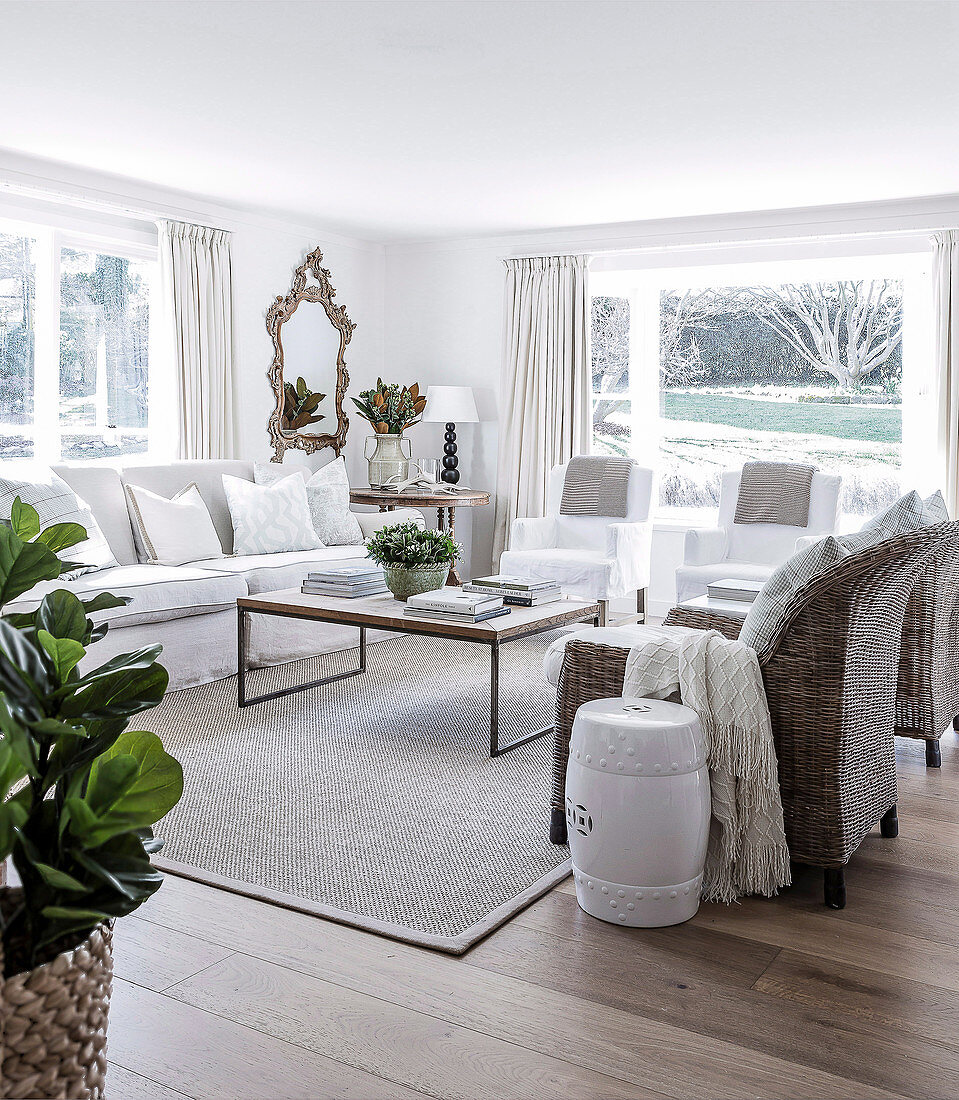 Living room in natural colors with various seating furniture and coffee table