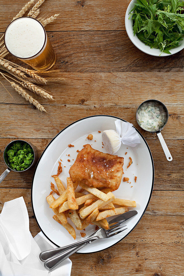 Fish and Chips served with tartar sauce, mushy peas and a pint of lager