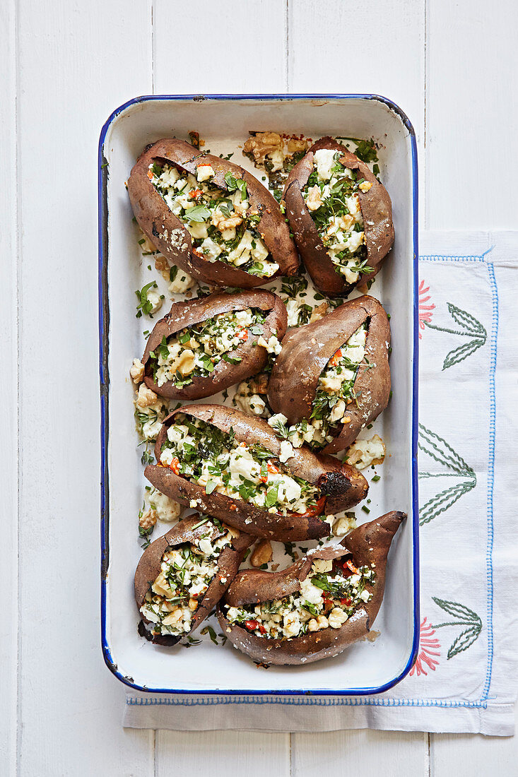 Cheese stuffed sweet potatoes in a roasting dish