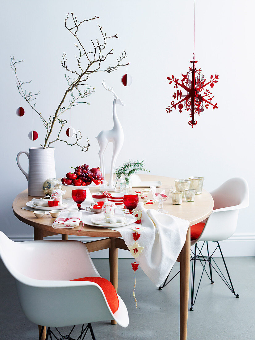 A table laid for Christmas in white and red