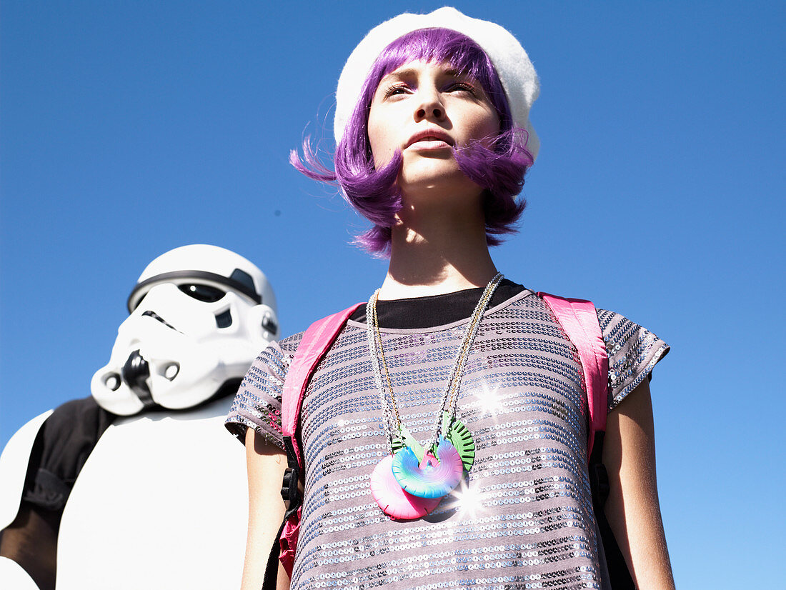 A young woman with purple hair standing next to a Stormtrooper