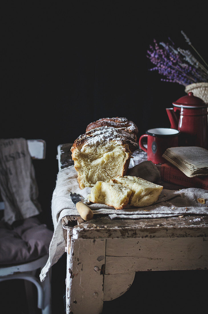 Tasty sweet cake covered with sugar powder on rustic table