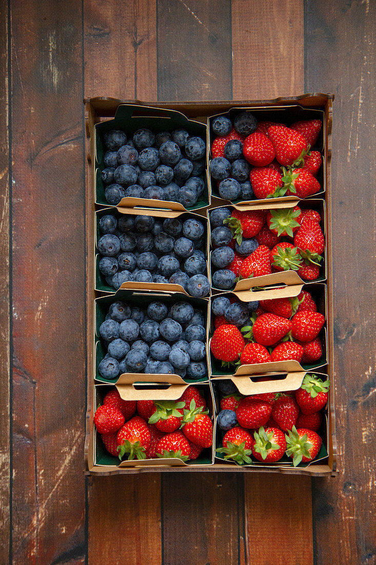 Blueberries and strawberries in crates