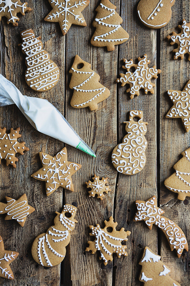 Gingerbread cookies decorated with royal icing on wooden table