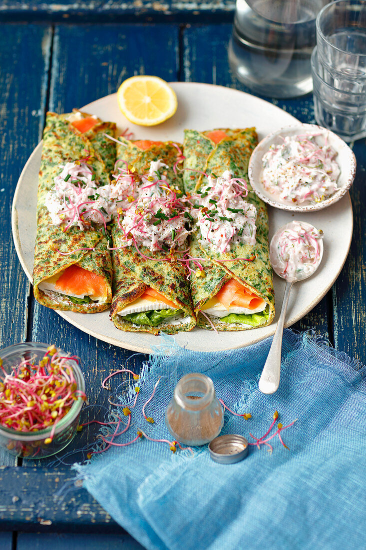 Spinach pancakes with camembert, smoked salmon and red radishes with yogurt