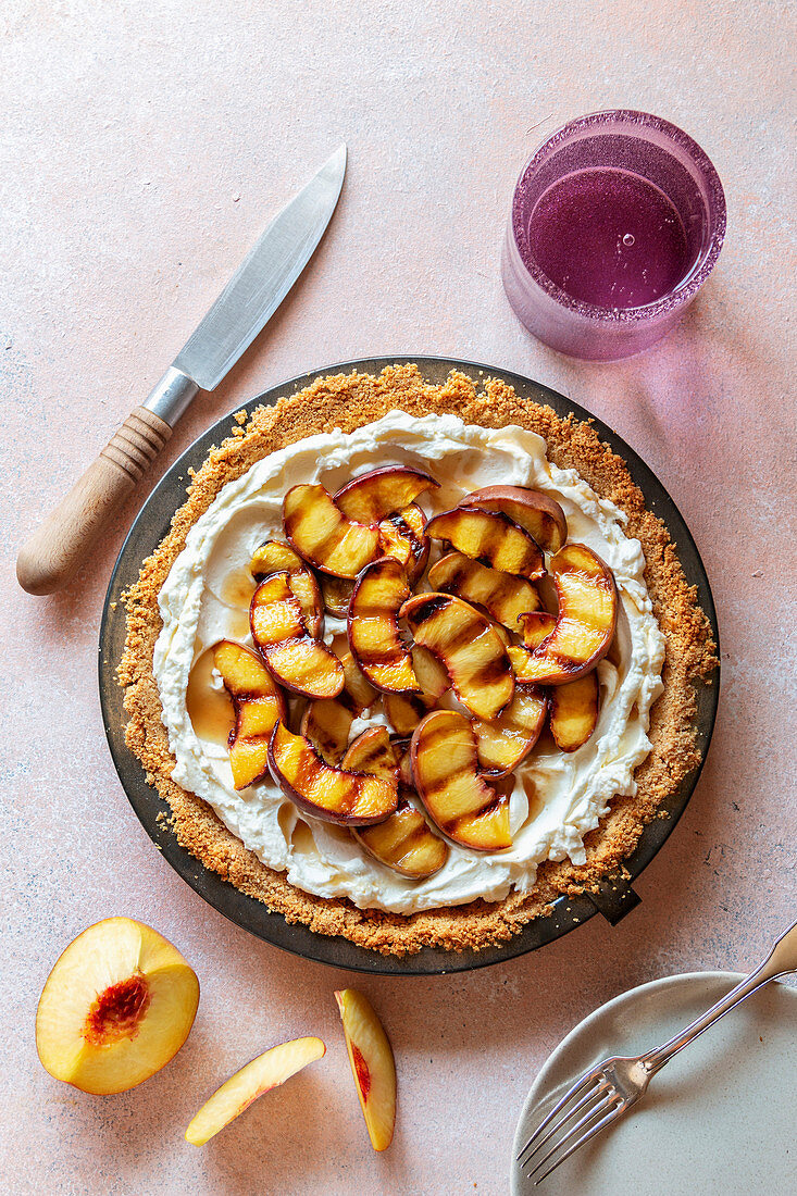 No bake pie with mascarpone cheese, whipped cream and topped with grilled peaches