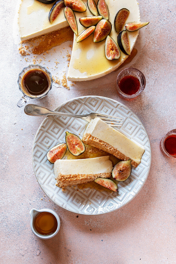 Ricotta cheesecake on the plate topped with fresh figs and drizzled with maple syrup