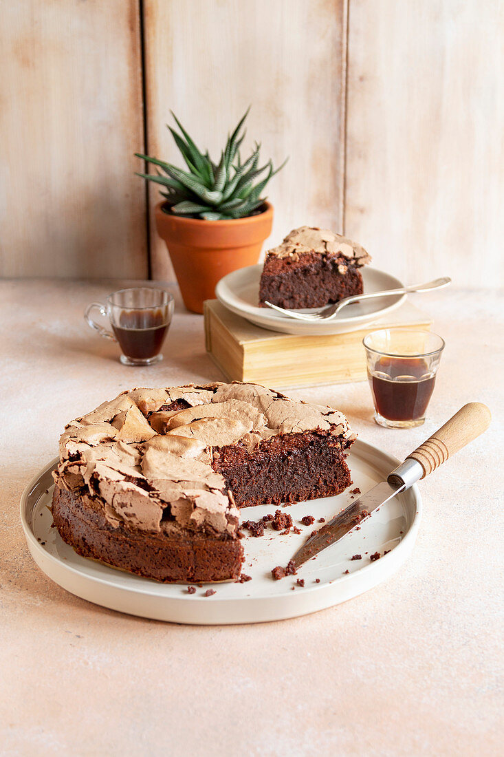 Brownie meringue cake and two cups of coffee on the table