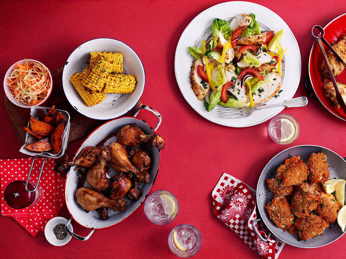Chicken wings, fried chicken, chicken salad, corn on the cob and coleslaw