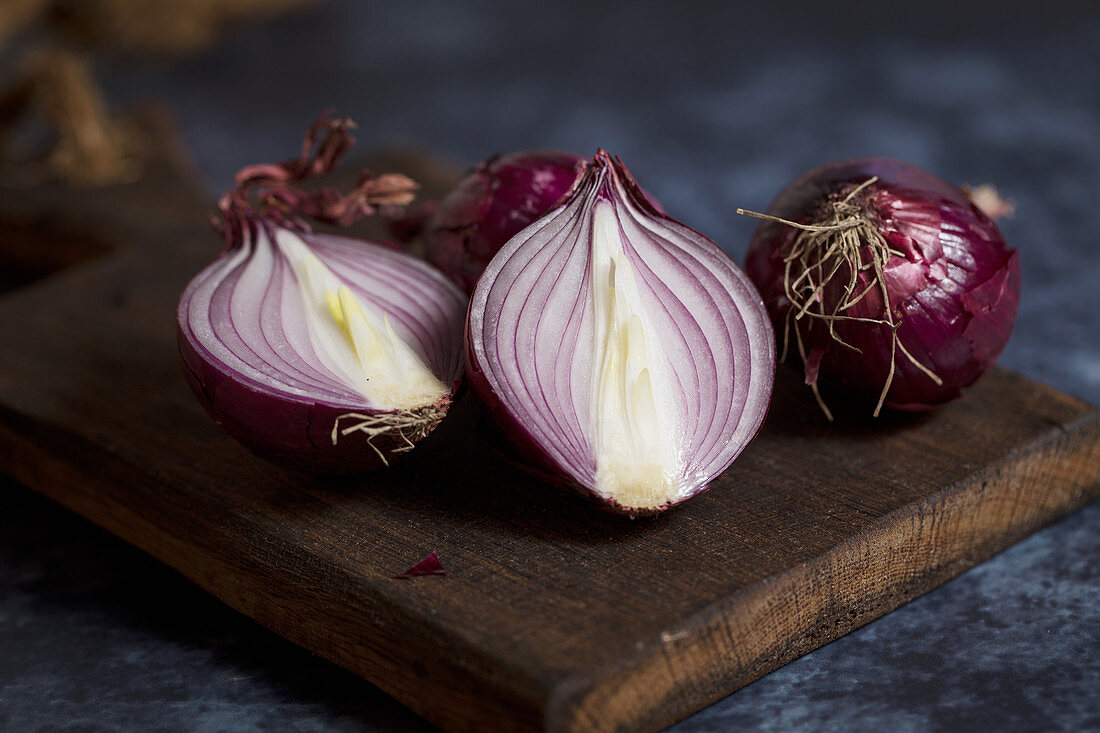 Red onions on a wooden chopping board