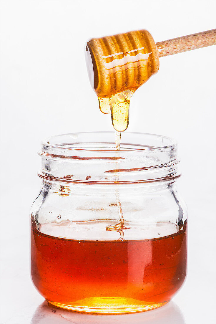 Honey trickling into a glass