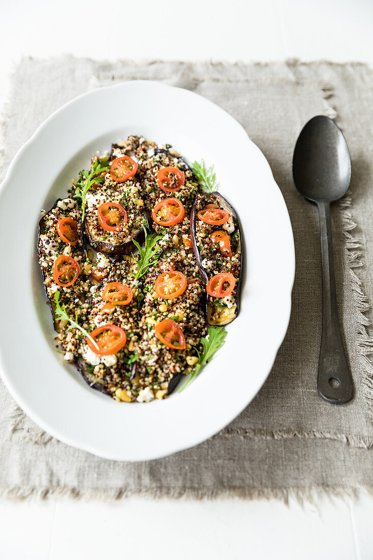 This is a baked aubergine dish topped with a mix of quinoa, fresh herbs and feta cheese (gluten free)