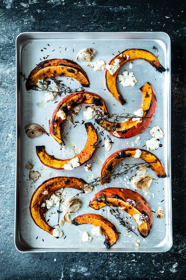 Pumpkin slices with garlic, thyme and feta cheese