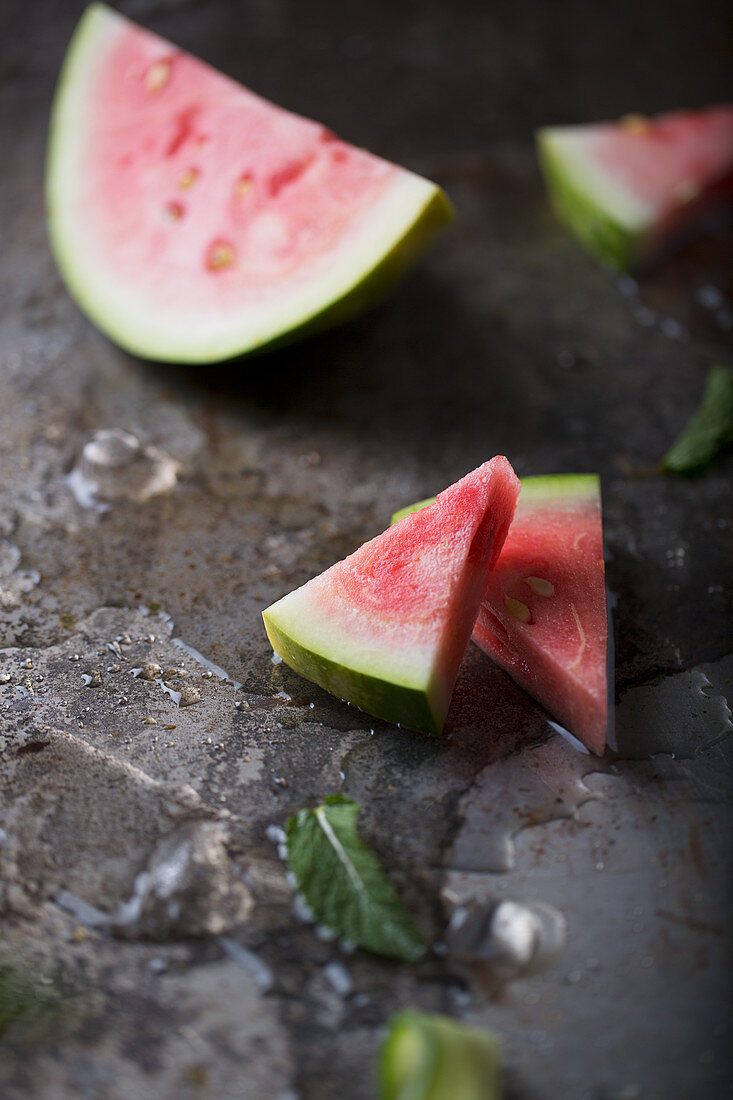 Watermelon Slices on a Metallic Background with ice and mint