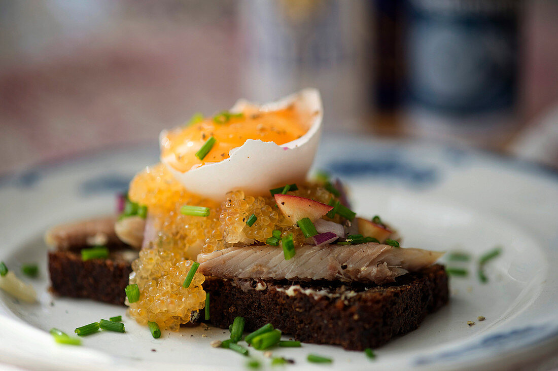 Dalarömacka (bread topped with smoked fish, fennel caviar and egg yolk, Sweden)