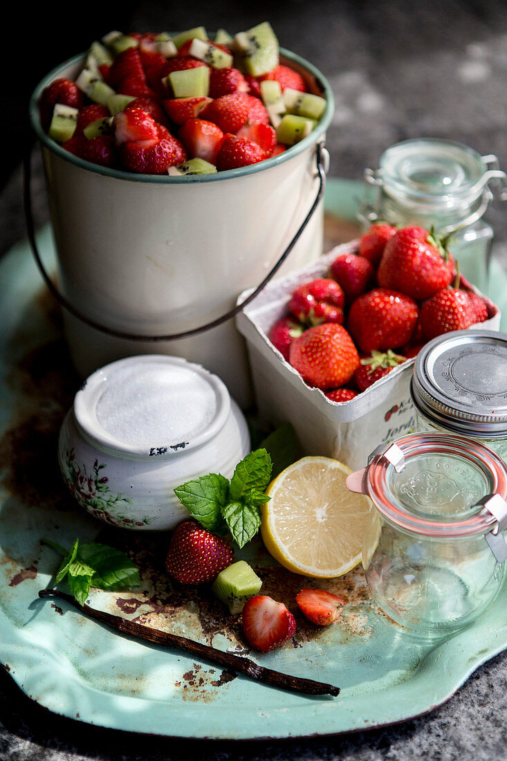 Ingredients and utensils for strawberry marmalade with kiwi